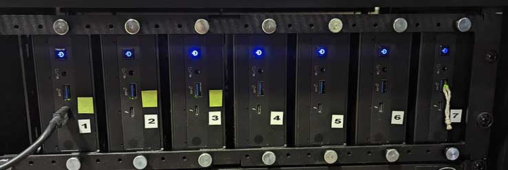 7 NUC computers mounted in a server rack with blue power on lights